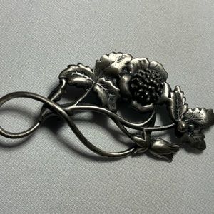 Antique silver tone flower brooch.